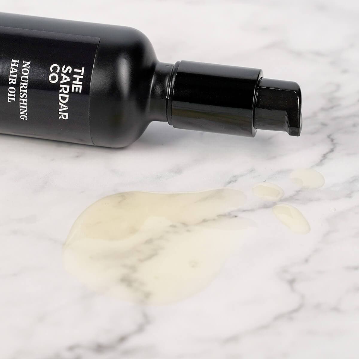 hair oil poured onto table to show natural colour