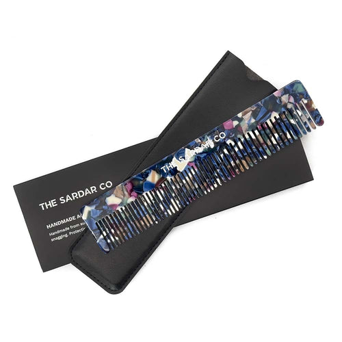 Acetate hair comb with pouch and outer packaging on white background