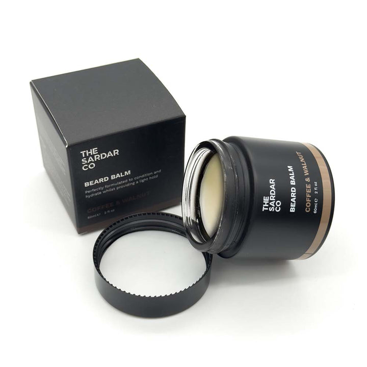Black beard balm container with open lid and black box labeled &