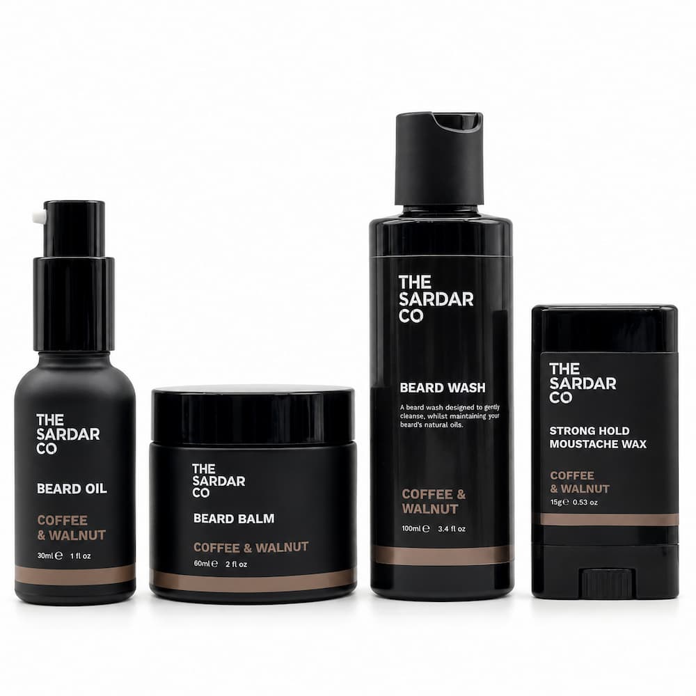 Four beard grooming products from The Sardar Co in a matching matte black and coffee &amp; walnut colorway, arranged on a clean white background.