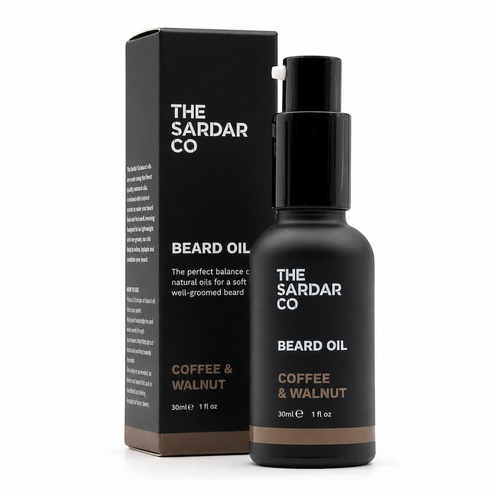 A bottle of The Sardar Co Beard Oil next to its black packaging box, featuring a matte black finish with white and brown text, on a clean white background.