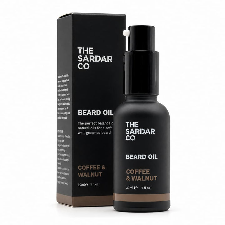 A bottle of The Sardar Co Beard Oil next to its black packaging box, featuring a matte black finish with white and brown text, on a clean white background.