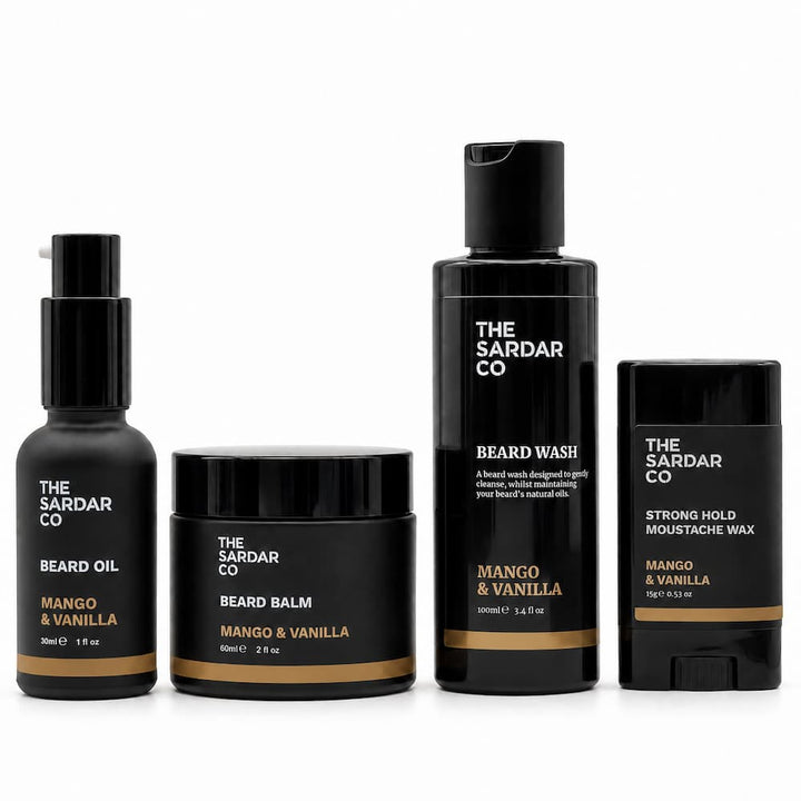 Four beard grooming products from The Sardar Co in Mango &amp; Vanilla scent, including beard oil, beard balm, beard wash, and strong hold moustache wax, arranged on a white background.