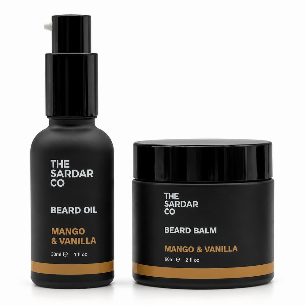 A beard care set from The Sardar Co, featuring a black pump bottle of Mango &amp; Vanilla Beard Oil and a matching black jar of Mango &amp; Vanilla Beard Balm, set against a plain white background.