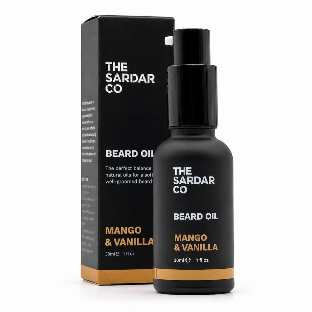 A bottle of The Sardar Co Beard Oil Mango & Vanilla next to its black packaging box on a clean white background.