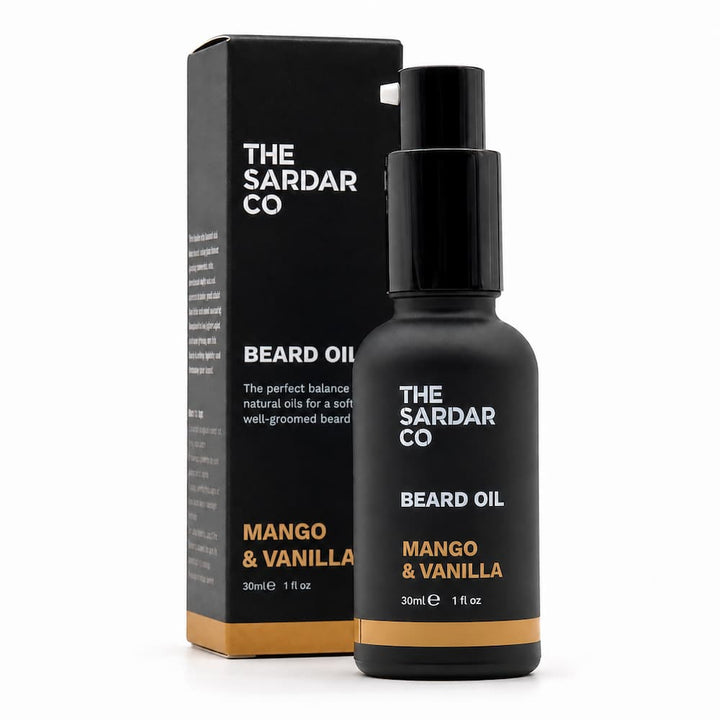 A bottle of The Sardar Co Beard Oil Mango &amp; Vanilla next to its black packaging box on a clean white background.