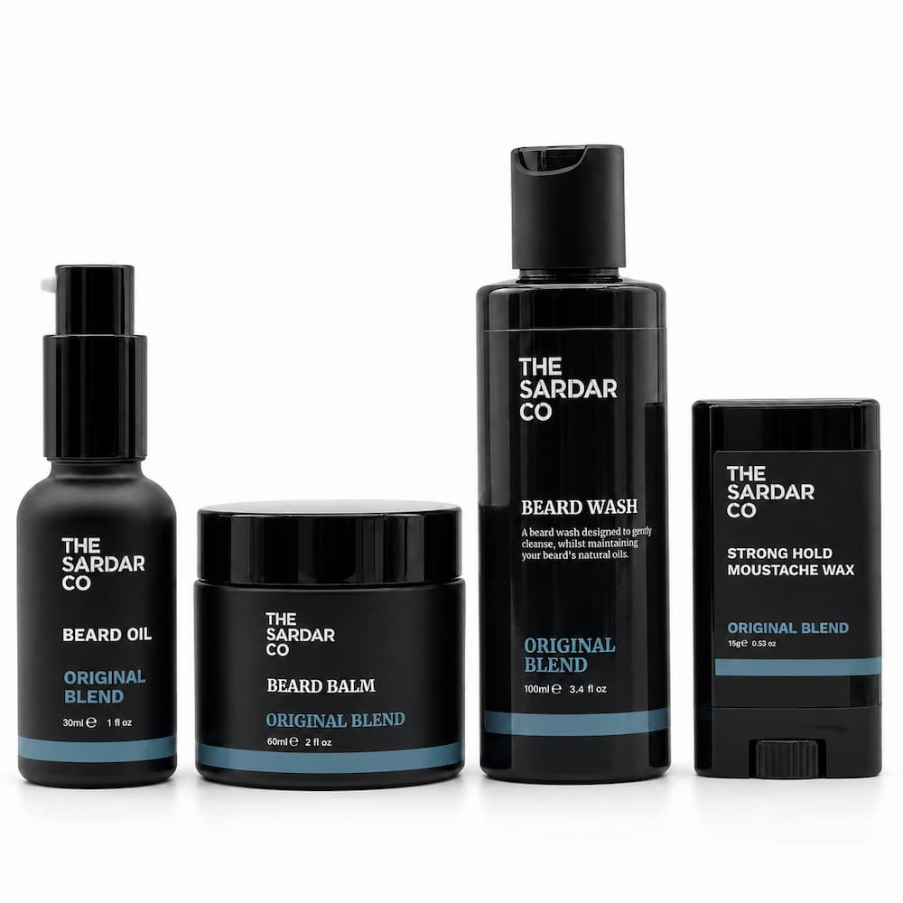 Four black beard grooming products from The Sardar Co on a white background: Beard Oil, Beard Balm, Beard Wash, and Strong Hold Moustache Wax.
