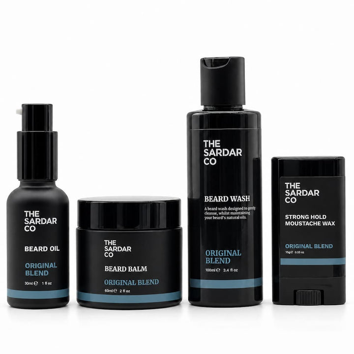 Four black beard grooming products from The Sardar Co on a white background: Beard Oil, Beard Balm, Beard Wash, and Strong Hold Moustache Wax.