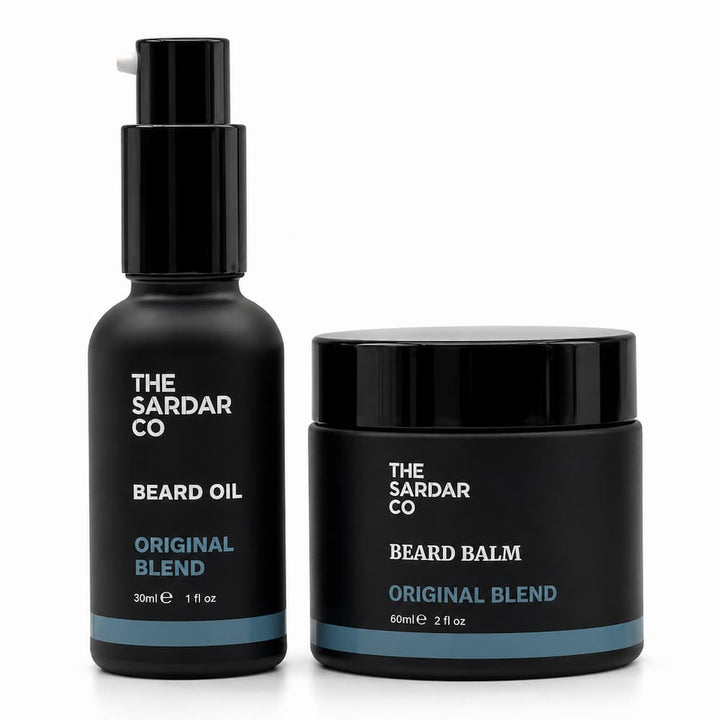 A black beard oil pump bottle and a black beard balm jar with white and blue text, both labeled &