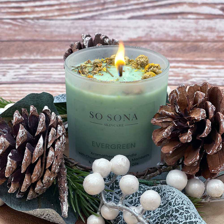Evergreen scented candle lit