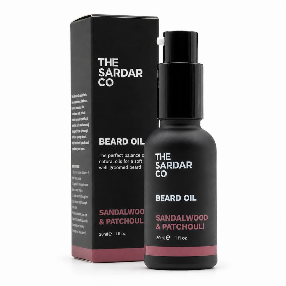 The Sardar Co Beard Oil in a matte black bottle with a black dropper cap, standing next to its black packaging box on a clean white background.