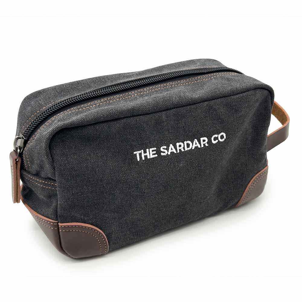 Black toiletry bag with 'The Sardar Co' branding on a white background